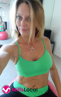 older woman in green sports bra